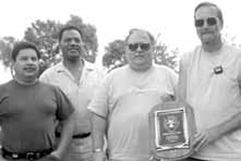 Business Service Section employees (from left to right)Tony Villa, Dwayne Foster, Ken Peterson and Wayne Smith display their section's Most Improved  safety award June 1999