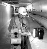 Gary Coppola uses a geodimeter to check angles during construction of the Main Injector
