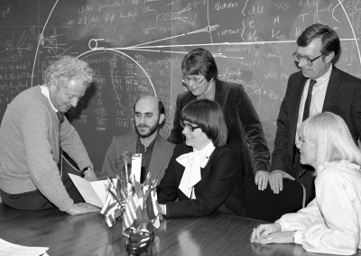 The early days: Leon Lederman (left) confers with Friends of Fermilab Jim Ruebush, physics teacher at St. Charles High School; Stanka Jovanovic (standing); Marge Bardeen (seated); Batavia banker Rober Riley and Judy Schramm, in 1985