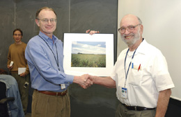 Fermilab Director Michael Witherell presented a certificate of appreciation and a commemorative photo to prairie project founder Bob Betz.