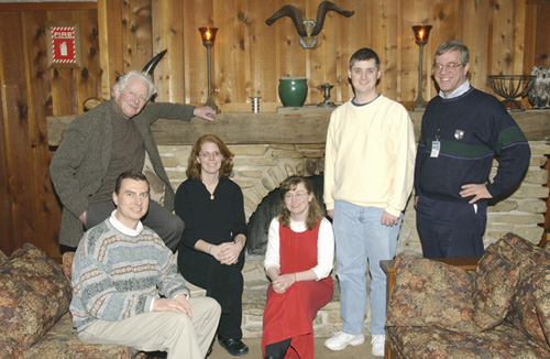 Gathering before the fireplace, and before lunch, at Chez Leon are (from left) Leon Lederman, Lederman Fellows Jay Dittman, Bonnie Fleming, Natalia Kuznetsova and Breese Quinn, and Lederman Fellows Committee chair Michael Albrow.