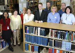 Gathering in the Information Resources Department's library are (from left to right) Celina Paul, Kathryn Duerr, Sue Hanson, Cyndi Rathbun, Heath O'Connell, Rob Atkinson, Jean Slisz, Kevin Williams, and Sandra Lee.