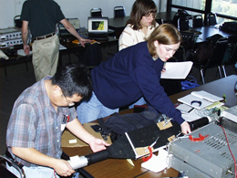 Mentor Jaehoon Yu (formerly of DZero), lead teachers Laura Nickerson, and Jennifer Ciaccio working with cosmic ray detectors at a QuarkNet workshop.