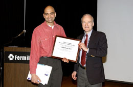 Universities Research Association, Inc. president Fred Bernthal (right) presents the URA Thesis Award to Valmiki Prasad, Ph.D., of the University of Chicago.