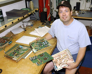Tech specialist Ken Koch with circuit boards for Tevatron Beam Dampers.