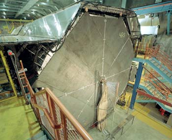 The 100-foot-long MINOS detector consists of 486 massive octagonal planes, numbered 0 through 485. Lined up like the slices of a loaf of bread, the planes consist of sheets of steel about 25 feet high and one inch thick, covered on one side with a layer of scintillating plastic. The whole detector weighs 6,000 tons.