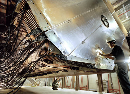 Two scientists work on the near detector of the MINOS neutrino experiment.