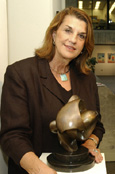 Patricia Armato  stands with her sculpture, 'Energy', in Fermilab's Art Gallery.