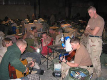 Danielle Peterson playing guitar while stationed in Iraq