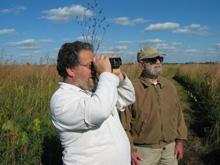 Joel Greenberg (left) explores Fermilab's prairie with Bob Betz.