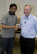 Dharmaraj Indurthy (left) accepts the 1st-prize award from David Finley