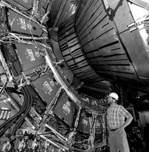 Fermilab physicist Pat Lukens inspects the positioning of one of CDF's end caps