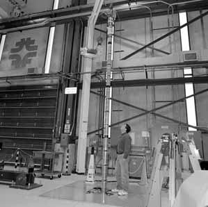 Project manager Jim Kerby inspects the 20 ft long LHC Magnet