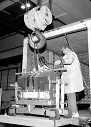 Dave Butler,left, and Delmar Miller unload the central silicon detector onto the crane at DZero