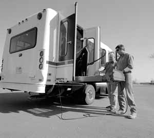 Ron Haynes (left) and Dan Nelson inspect a new Fermilab Taxi