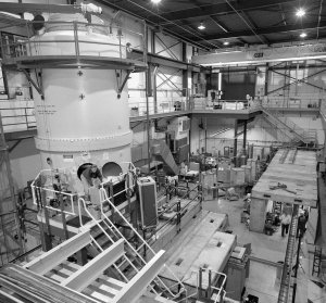 The research facility for electron cooling includes a 25-foot-high Pelletron accelerator (left), which produces a continuous high-energy electron current with the highest beam power in the world.