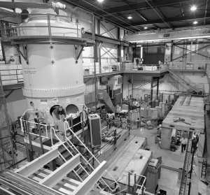The research facility for electron cooling includes a 25-foot-high Pelletron accelerator (left), which produces a continuous high-energy electron current with the highest beam power in the world.