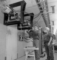 Jerry Leibfritz (left) and Jerry Nelson install a 7-foot-long module of the cooling section, in which electrons will travel side by side with antiprotons.