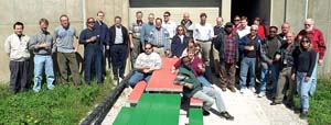 Crew members gather outside the MiniBooNE detector building