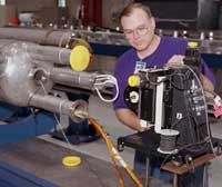 Using a stretched-wire field measurement system, Steve Gould verifies the magnetic alignment of a quadrupole magnet.