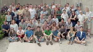 BooNE collaborators pose in front of the entrance to their experiment.