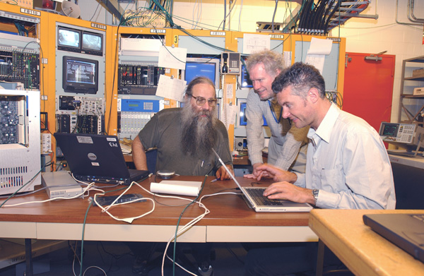 Jim Sebek (left), an accelerator physicist at the Stanford Synchrotron Radiation Lab (SSRL), Marc Ross (middle), a physicist and group leader from the Stanford Linear Accelerator Center, and Till Straumann, an accelerator physicist and controls system specialist at SSRL, recently visited Fermilab to contribute their accelerator expertise to the Tevatron.I hope that we can have a positive impact on the Tevatron, and we realize that a lot of people have been working hard on Run II, Ross said.