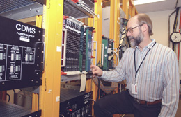 New CDMS Project Manager Dan Bauer checks out the experiement's circuitry. Bauer, who has been working with CDMS since 1995, recently relocated from the University of California at Santa Barbara.