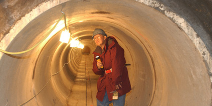 The NuMI carrier tunnel, here inspected by Tony Ramos, will host the beam line that transports protons from Fermilab's Main Injector accelerator to the NuMI target hall.