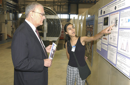 Muge Karagoz Unel, of Northwestern University, offered OSTP Director John Marburger a personal poster session on Beam Halo Monitoring at CDF, during Marburger's visit to Fermilab on August 1, 2002.