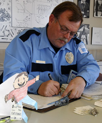 Flat Stanley gets a visitor's pass from Security Guard Robert Holle