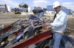 Eric Mieland of Fermilab s Environment,Safety and Health section examines material that has been removed from the deconstruction of the old Neon Compressor Building in the fixed-target area.New construction methods mean that nearly 85 percent of the material from old buildings in this area will be recycled,reducing costs and enabling a more complete cleanup.Mieland calls it a paradigm shift in the way old buildings are removed at the end of their useful life.