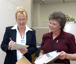 Barbara Book and Dianne Snyder compare notes while setting up the Users Office to handle new demands for foreign user data.