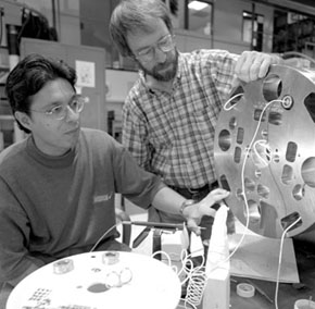 Tug Arkan and Rodger Bossert examine the end structure of one of the final model magnets.