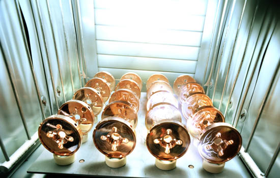 Precisely machined copper disks, components of a room-temperature radiofrequency accelerating structure. This 'warm' technology was not selected for the design of the proposed International Linear Collider.