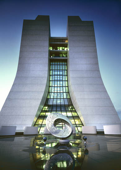 Fermilab's Wilson Hall and, in the foreground, the sculpture 'Mobius Strip' by Fermilab's founding director Robert Wilson.