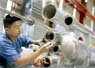 A technician cleans a sealing surface prior to applying a vacuum in order to leak-check a superconducting quadrupole magnet built by Fermilab's Technical Division for the Large Hadron Collider at CERN.