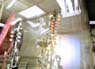 Scientist James Santucci assembles a superconducting RF structure in a clean room at Fermilab. The niobium cavities are a key component of the 