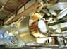 Scientist Ioanis Kourbanis checks a beam focusing horn for Fermilab's MiniBooNE experiment. The goal of the experiment is to answer the question of how many types of neutrinos exist.