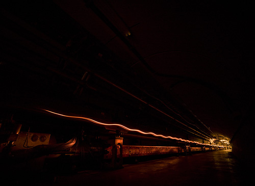 An artistic image depicts the acceleration of particle beams in the Tevatron tunnel